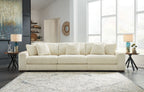 Ivory sectional sofa with chaise seating and ribbed upholstery, shown in living-room style.