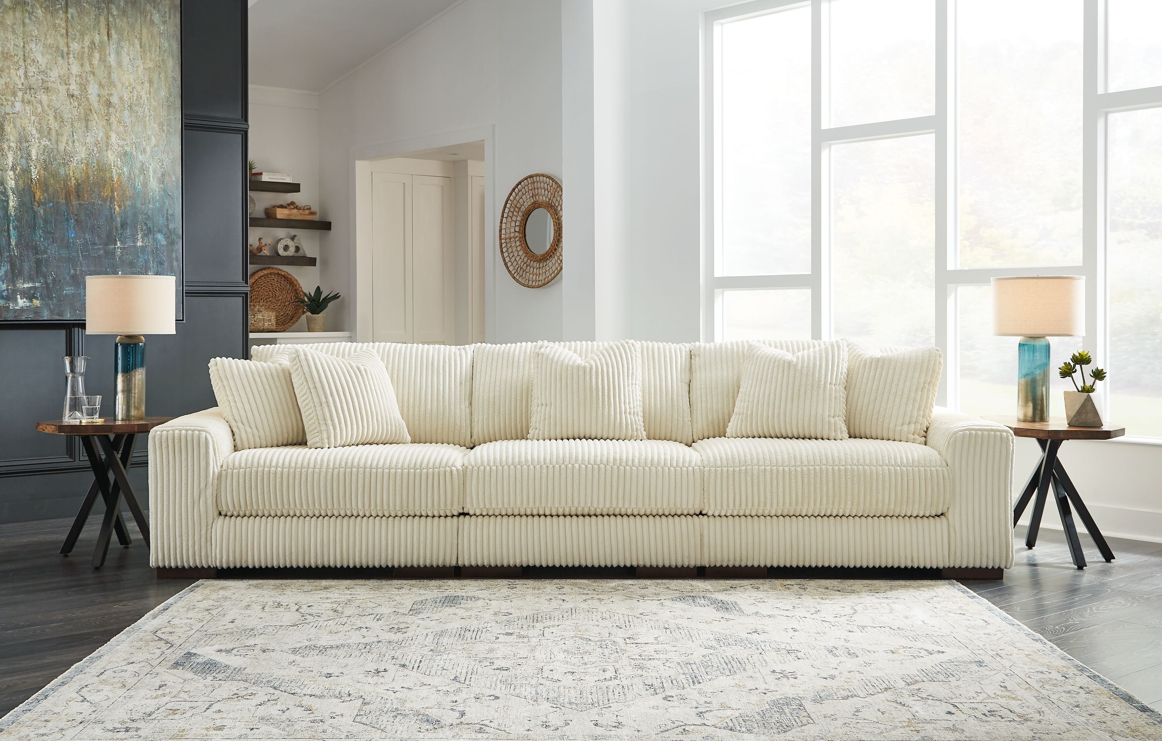 Ivory sectional sofa with chaise seating and ribbed upholstery, shown in living-room style.