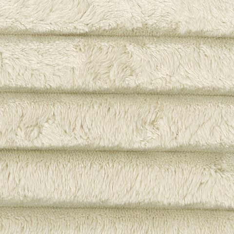 Ivory sectional upholstery fabric close-up with ribbed corduroy texture and soft pile.