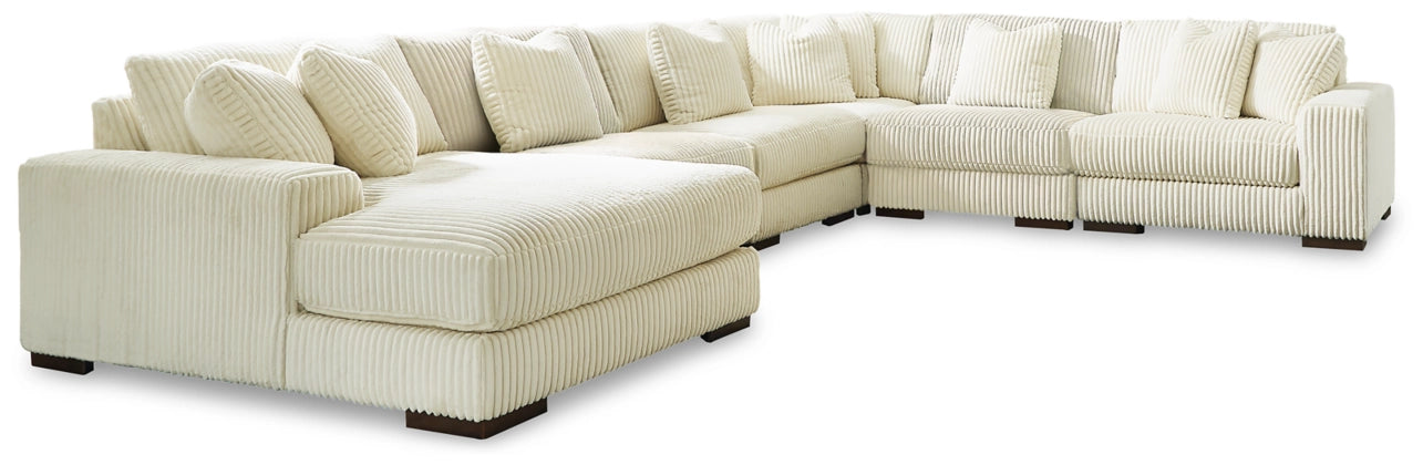Sectional sofa with left chaise, light ivory ribbed upholstery and plush back cushions