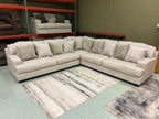 Light gray-beige sectional sofa with three-seat chaise and pillow back