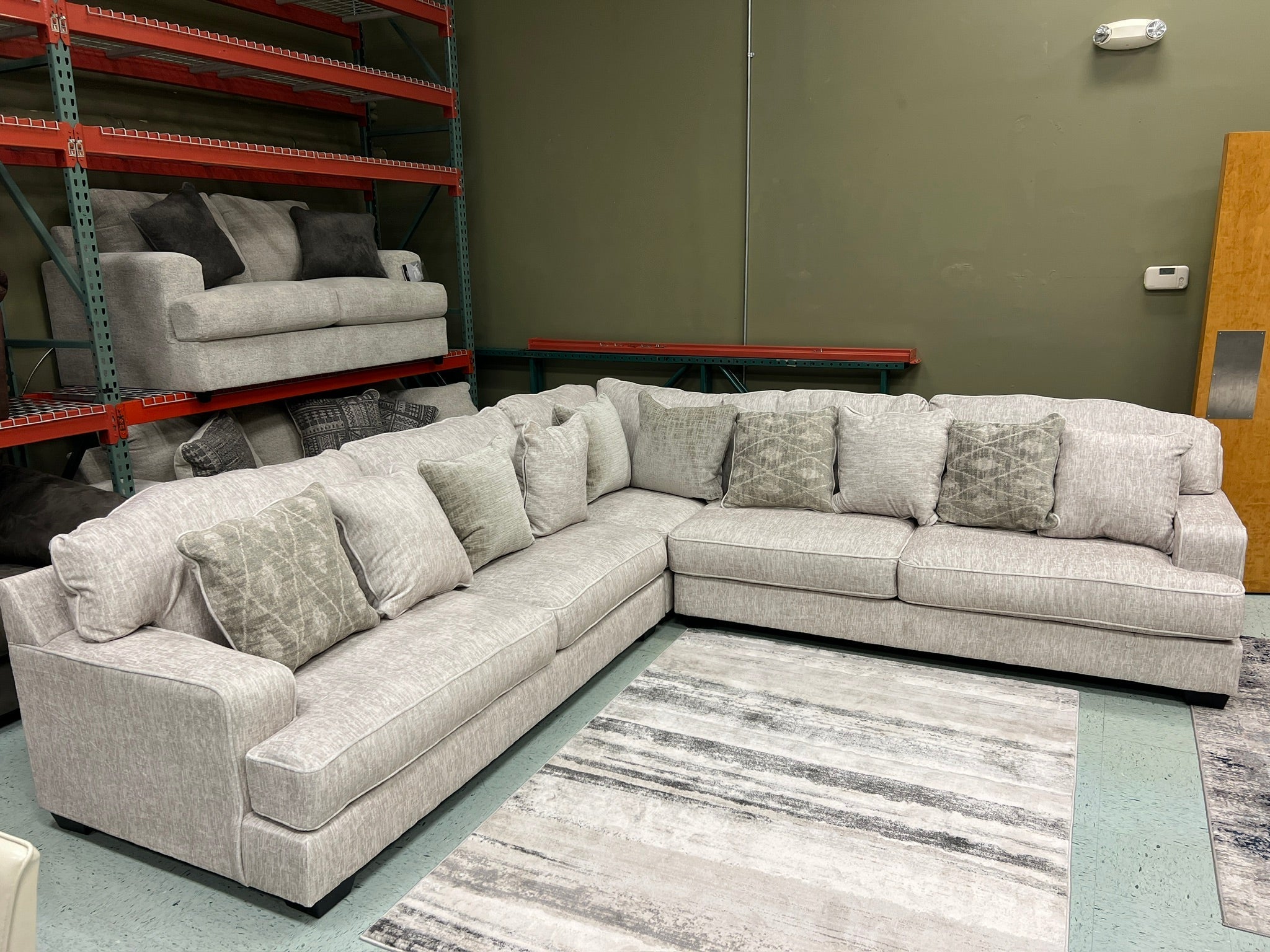 Sofa sectional with light beige upholstery and angled chaise seating