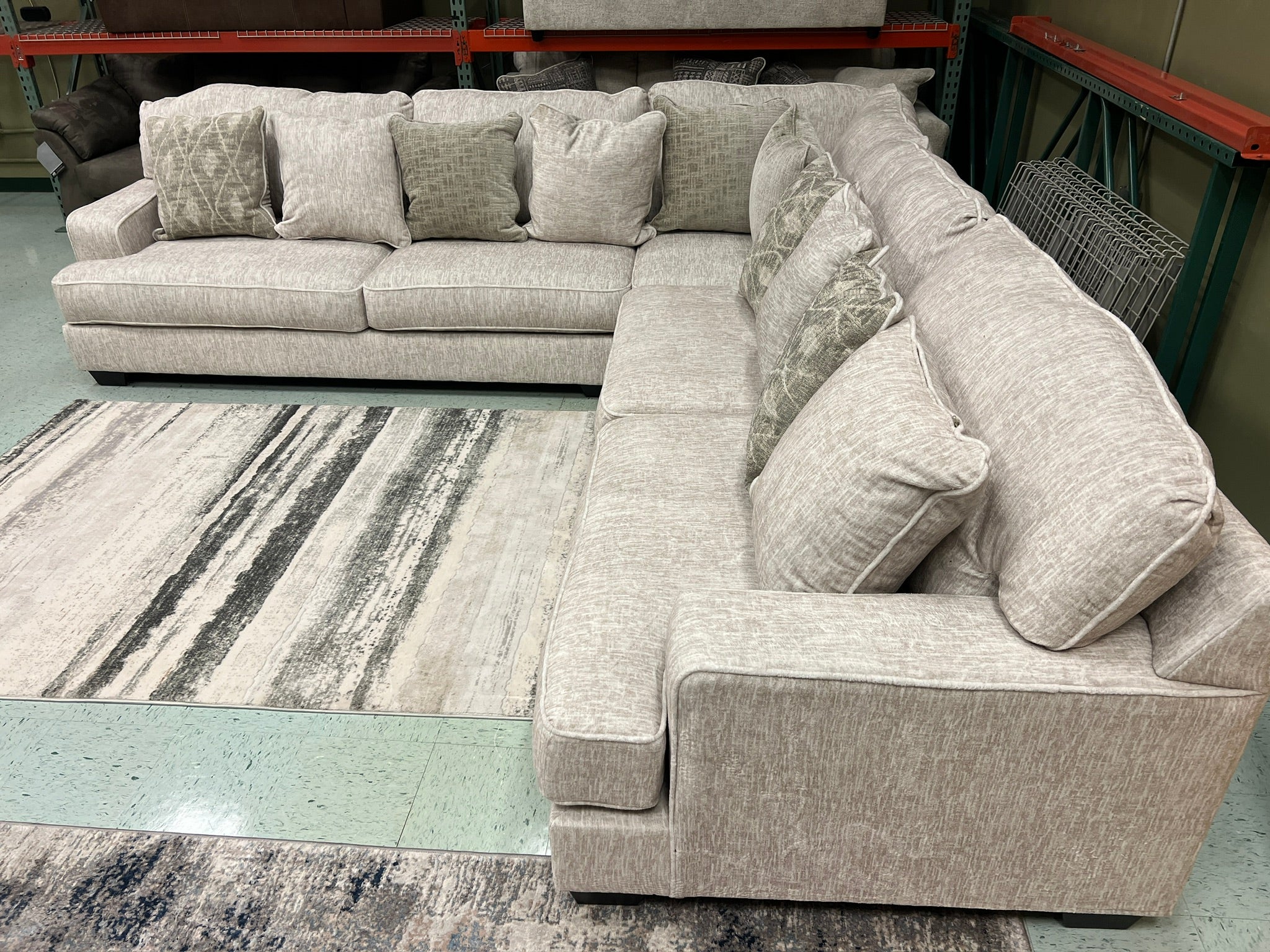 Light beige L-shaped sectional sofa with plush seat and corner chaise
