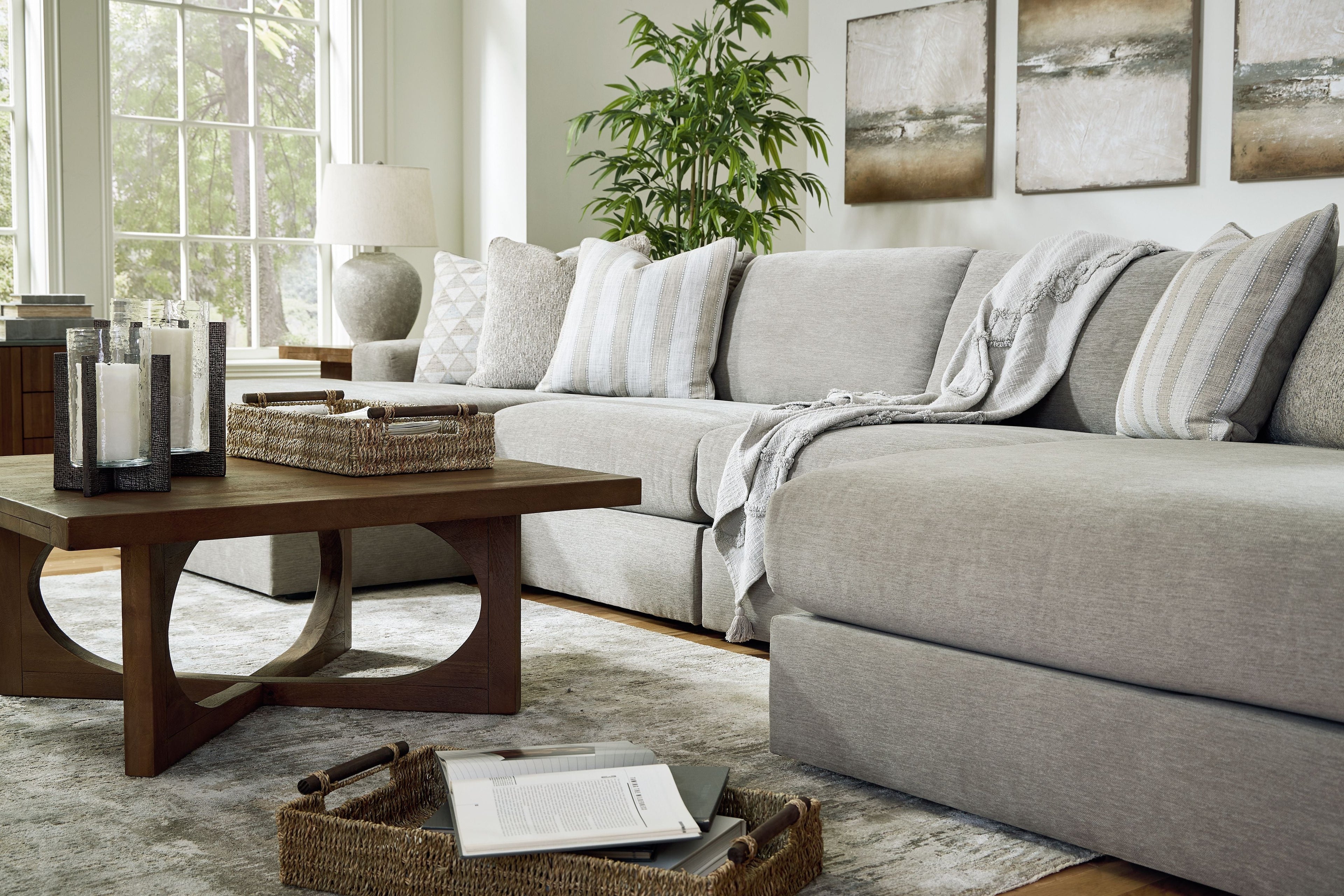 Gray sectional sofa with chaise extension and striped and geometric throw pillows.