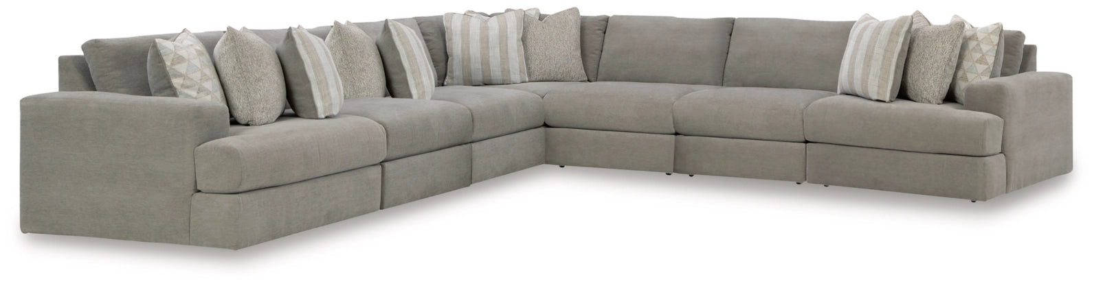 Ash-gray fabric sectional sofa with corner and several accent pillows along the back