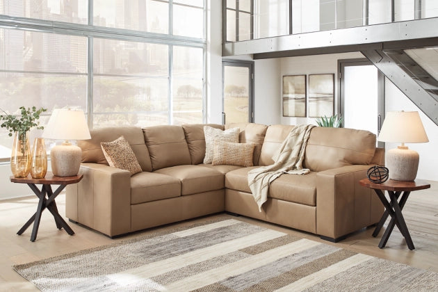 Two-tone sectional sofa with tufted back cushions, chaise-style corner, and tan-and-cream upholstery