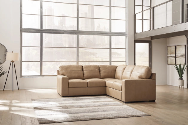 Two-tone sectional sofa with tufted back and wide arms, tan-and-cream upholstery