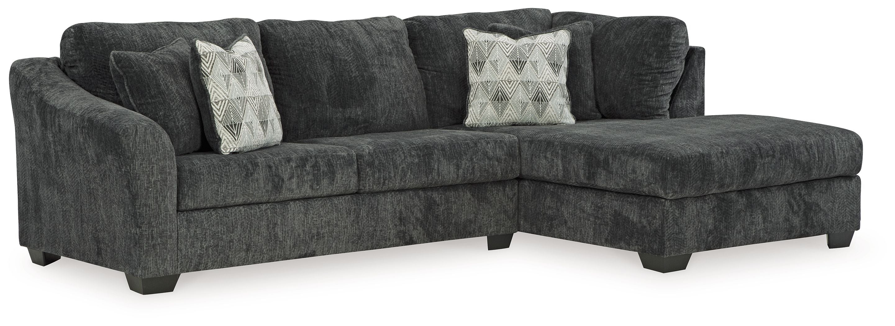 Dark charcoal corner chaise sectional sofa with tufted seat cushions and accent pillows