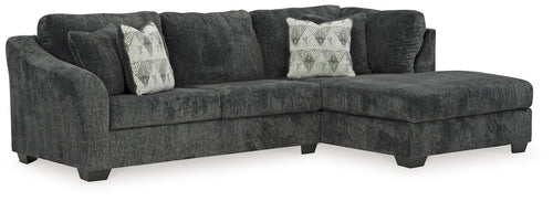Dark charcoal corner chaise sectional sofa with tufted seat cushions and accent pillows