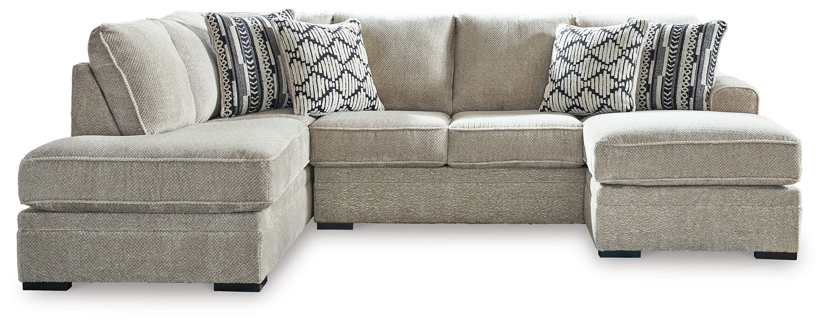 Light beige sectional sofa with corner chaise and patterned accent pillows
