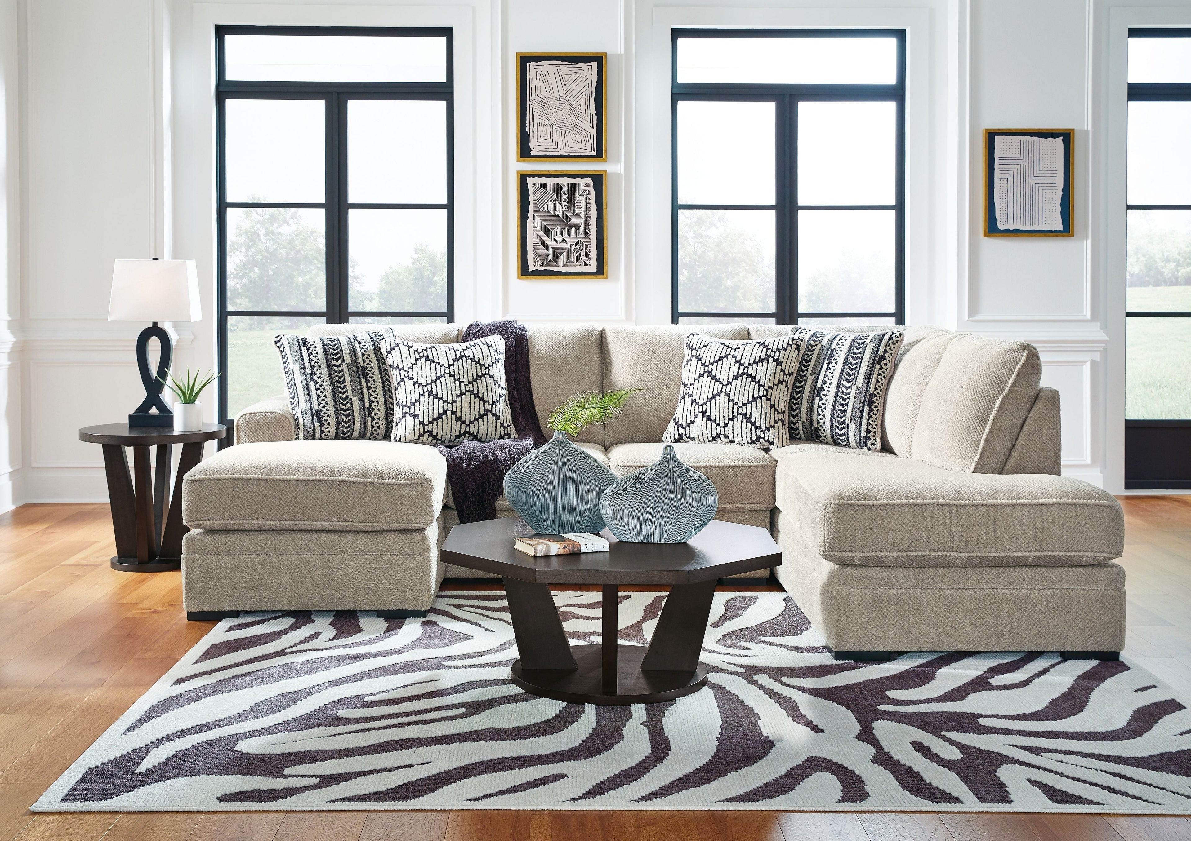 Light beige sectional sofa with chaise and patterned accent pillows