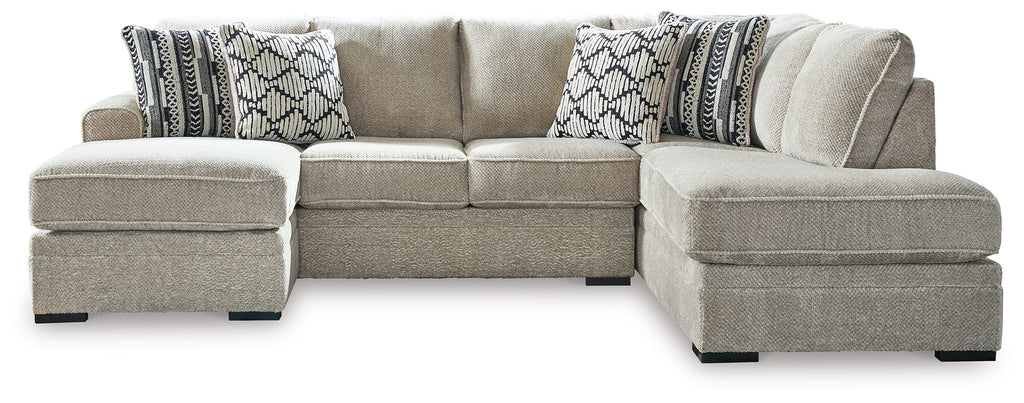 Light beige sectional sofa with corner chaise and patterned accent pillows