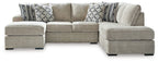 Light beige sectional sofa with corner chaise and patterned accent pillows