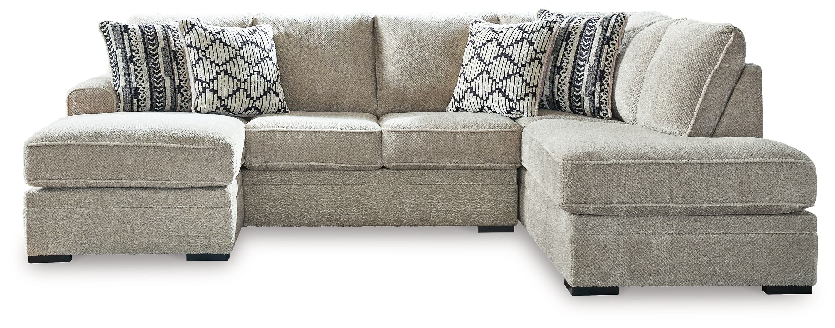 Light beige sectional sofa with corner chaise and patterned accent pillows