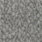 Close-up of grey fabric upholstery with textured tufted surface.