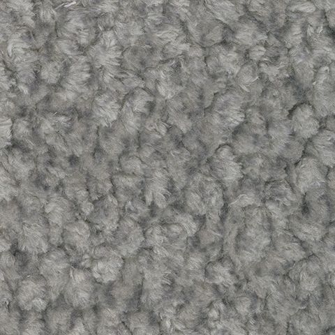Close-up of grey fabric upholstery with textured tufted surface.