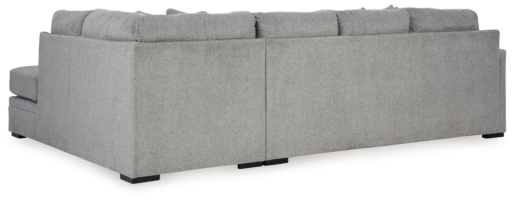 Grey sectional sofa profile view with chaise seat and boxy back cushions.