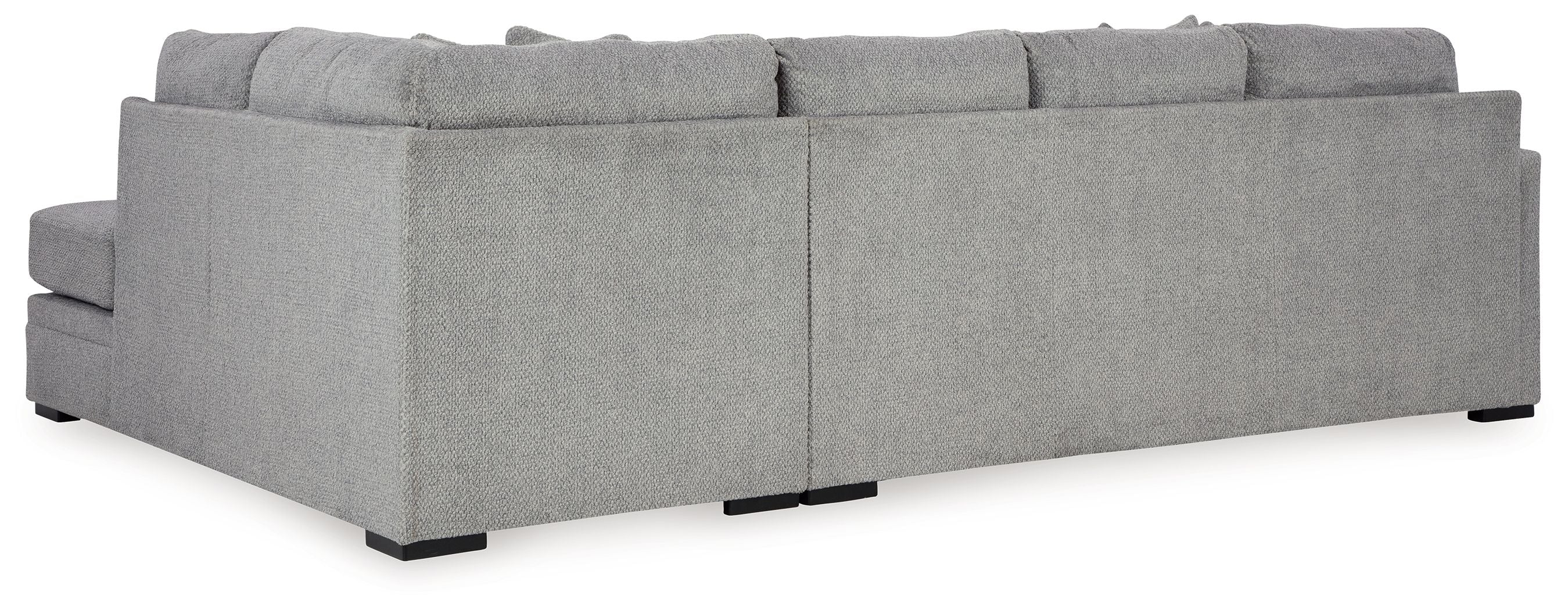 Grey sectional sofa profile view with chaise seat and boxy back cushions.