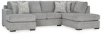 Grey sectional sofa with corner chaise and patterned accent pillows.