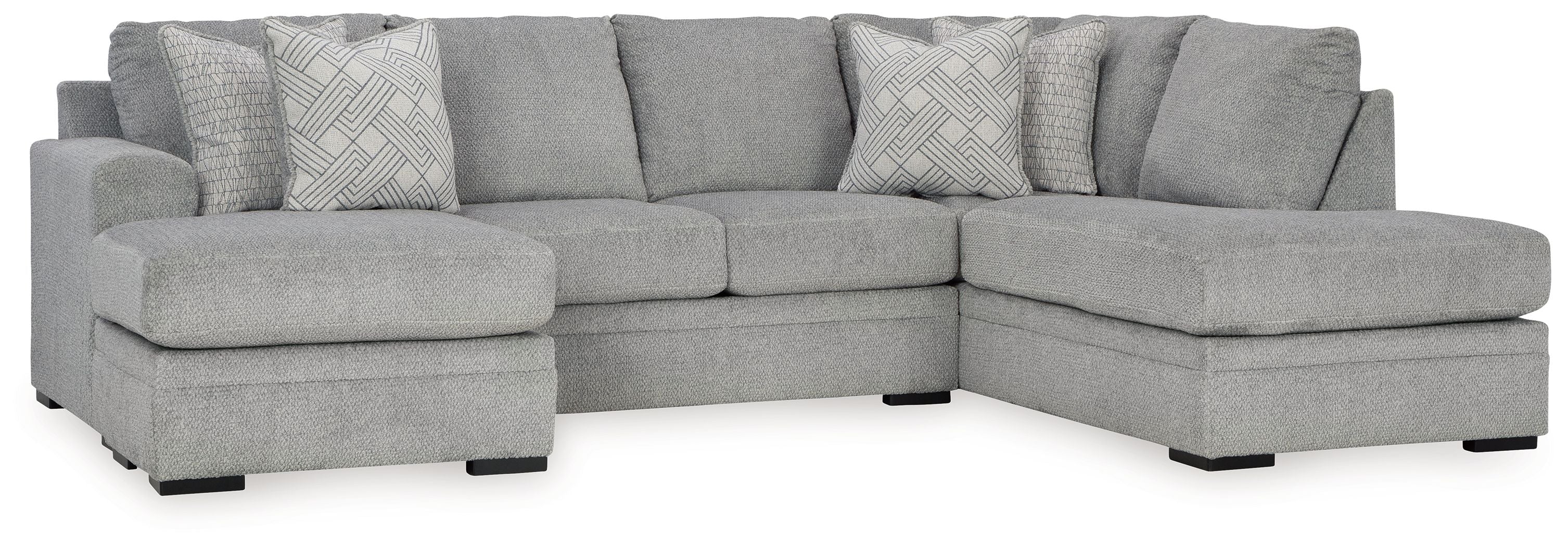 Grey sectional sofa with corner chaise and patterned accent pillows.