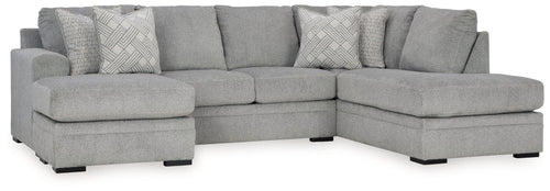 Grey sectional sofa with corner chaise and patterned accent pillows.