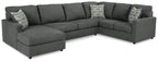 Charcoal sectional sofa with chaise, tufted cushions, and two decorative throw pillows