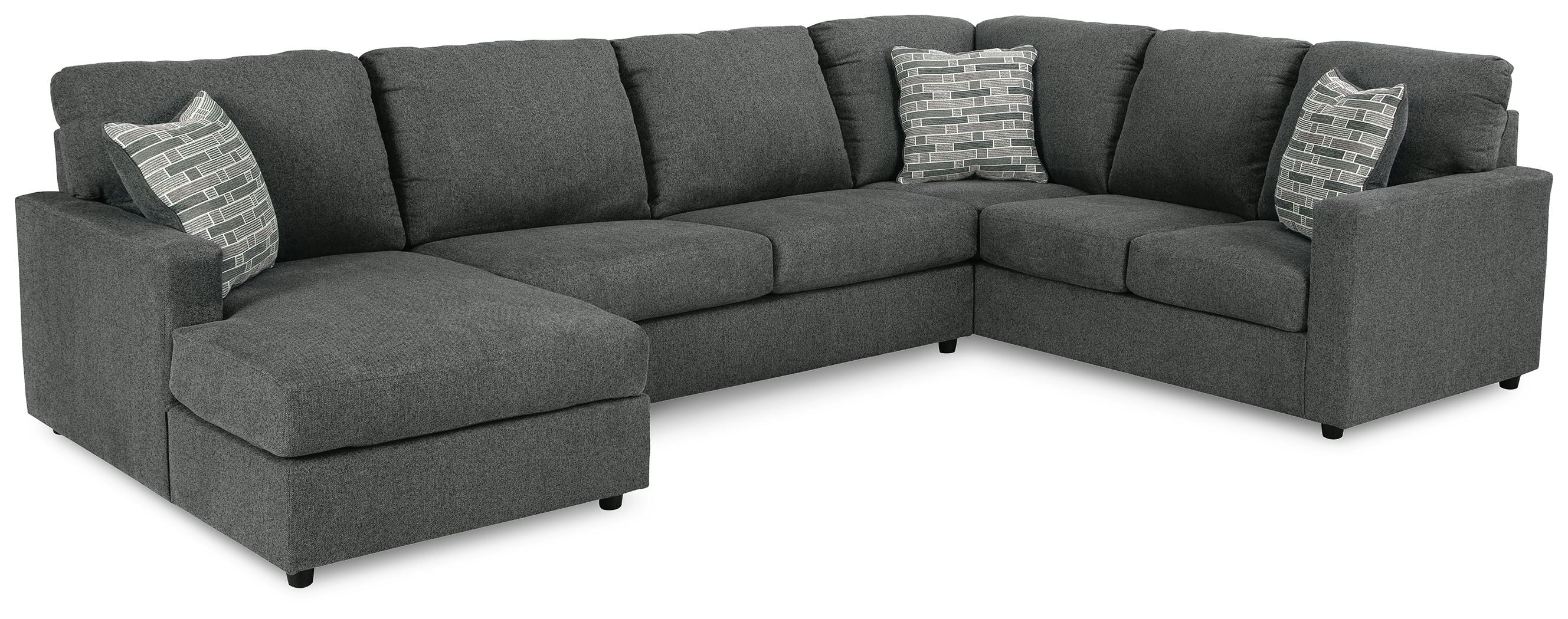 Charcoal sectional sofa with chaise, tufted cushions, and two decorative throw pillows