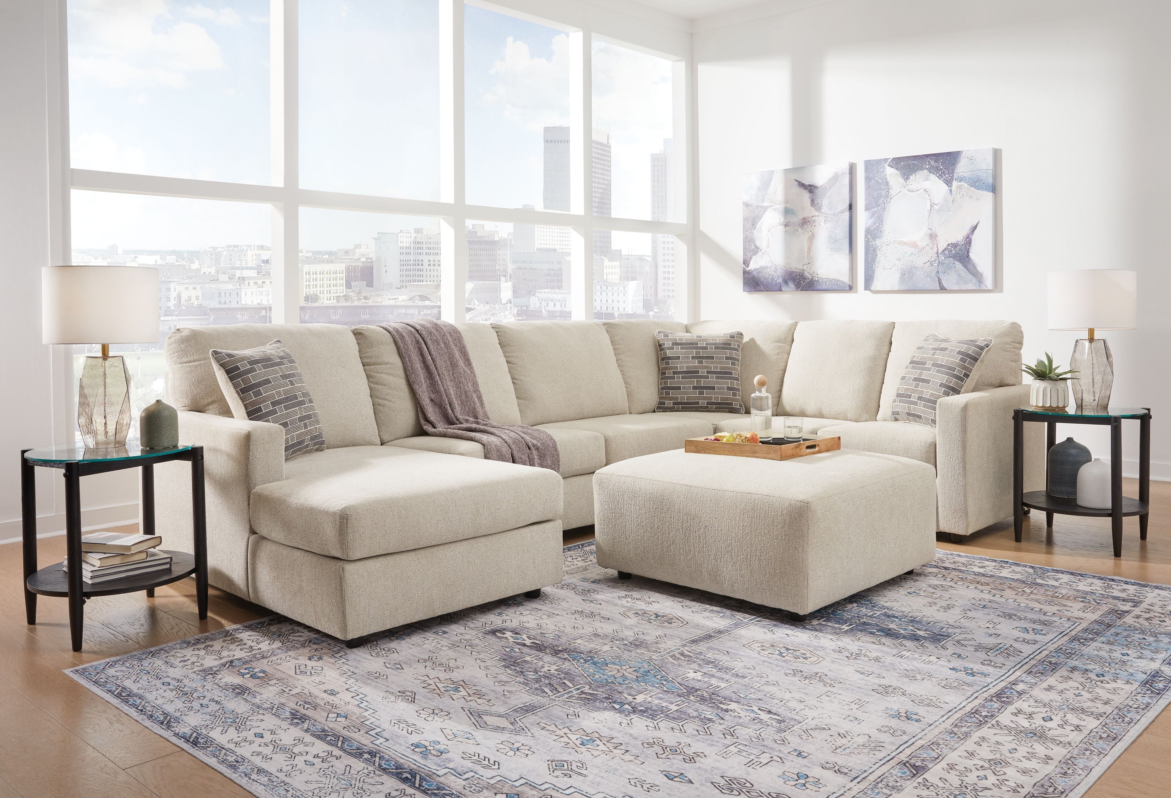 Corner chaise sectional sofa, light beige upholstery with tufted seat cushions and throw pillows