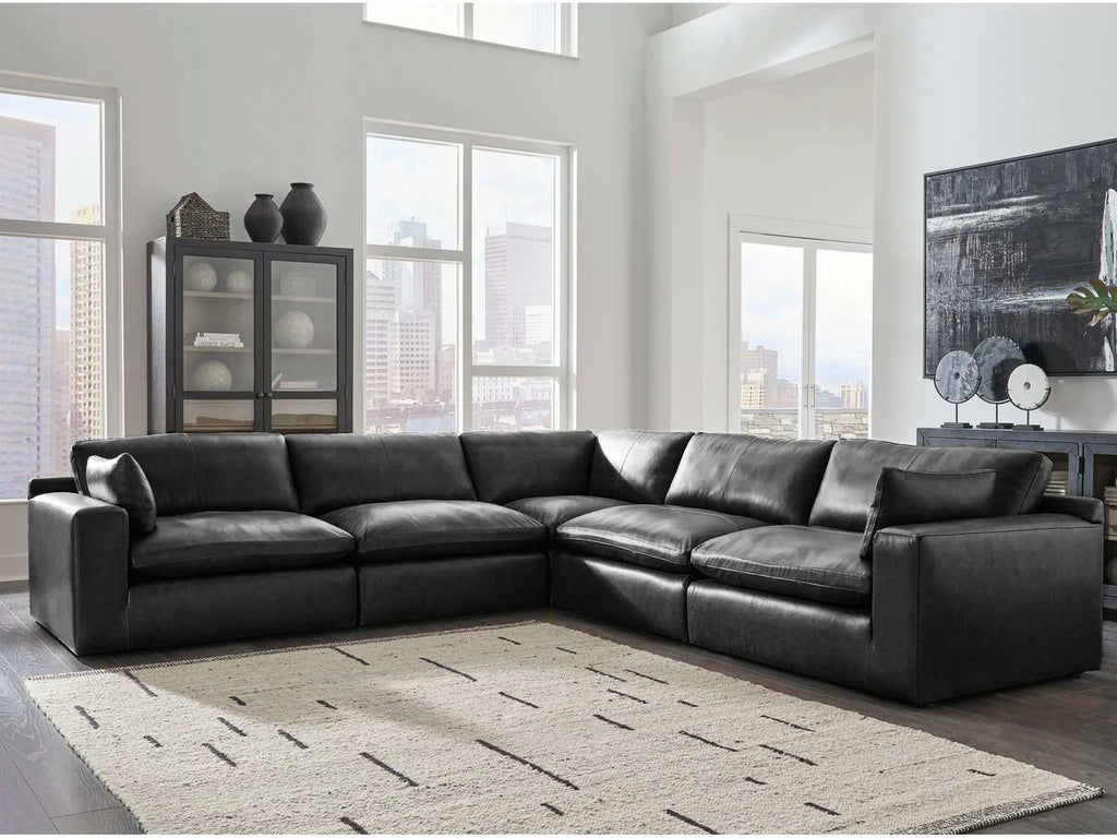 Black sectional sofa with chaise section, wide arms, and multiple back cushions