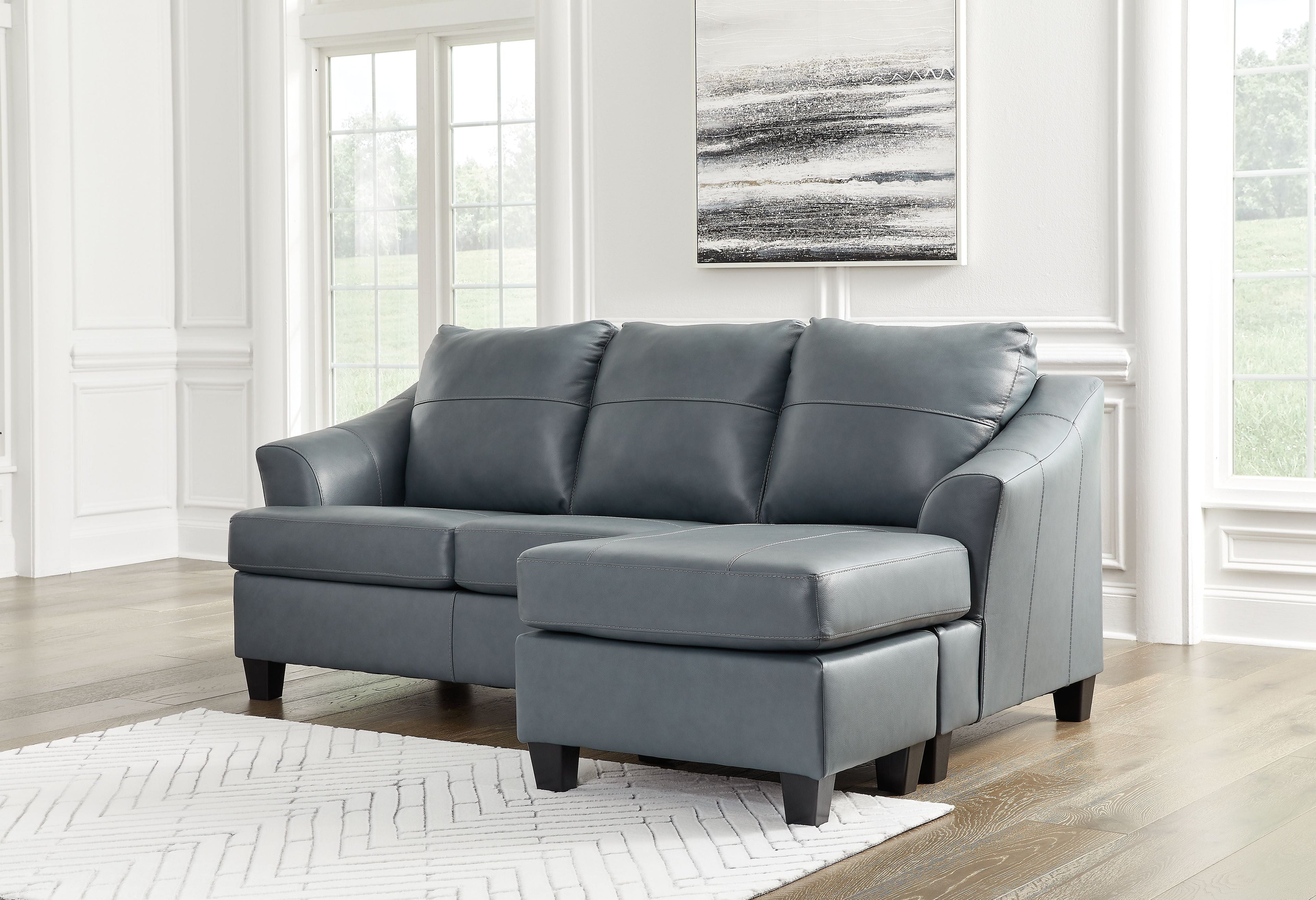 Steel sectional sofa with padded arms and chaise ottoman, gray upholstery