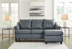 Steel sectional sofa with three seat cushions, tufted back, and corner chaise