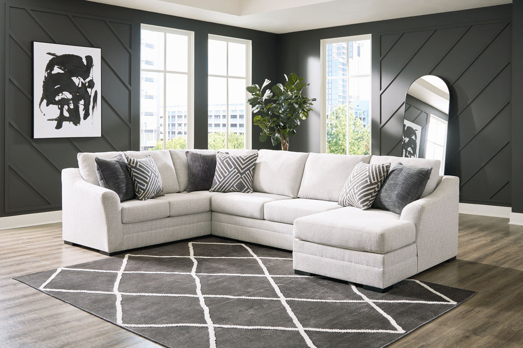 Stone corner sectional with chaise, light upholstery and patterned accent pillows, plush seat cushions