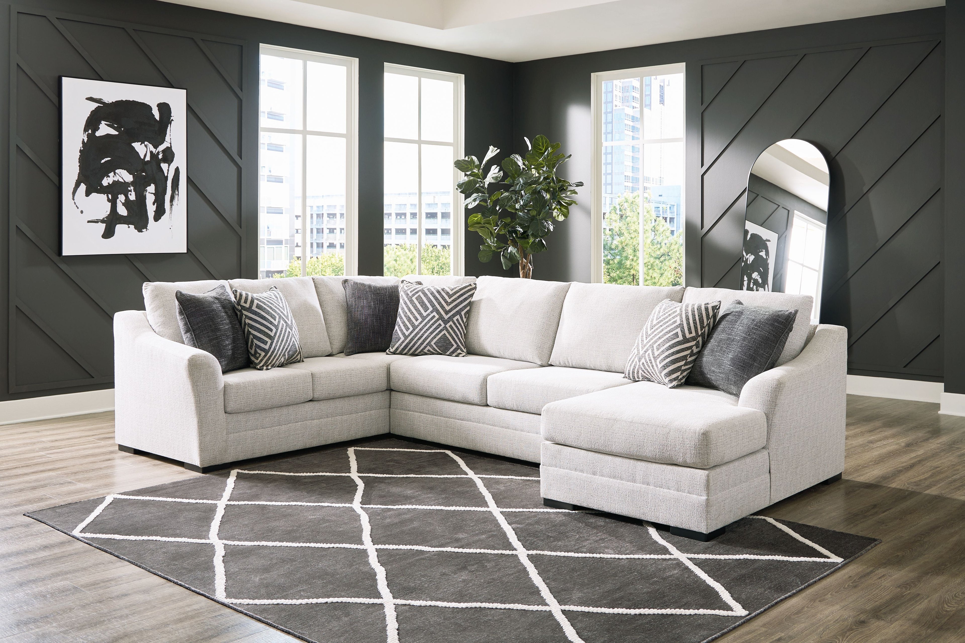 Stone corner sectional with chaise, light upholstery and patterned accent pillows, plush seat cushions