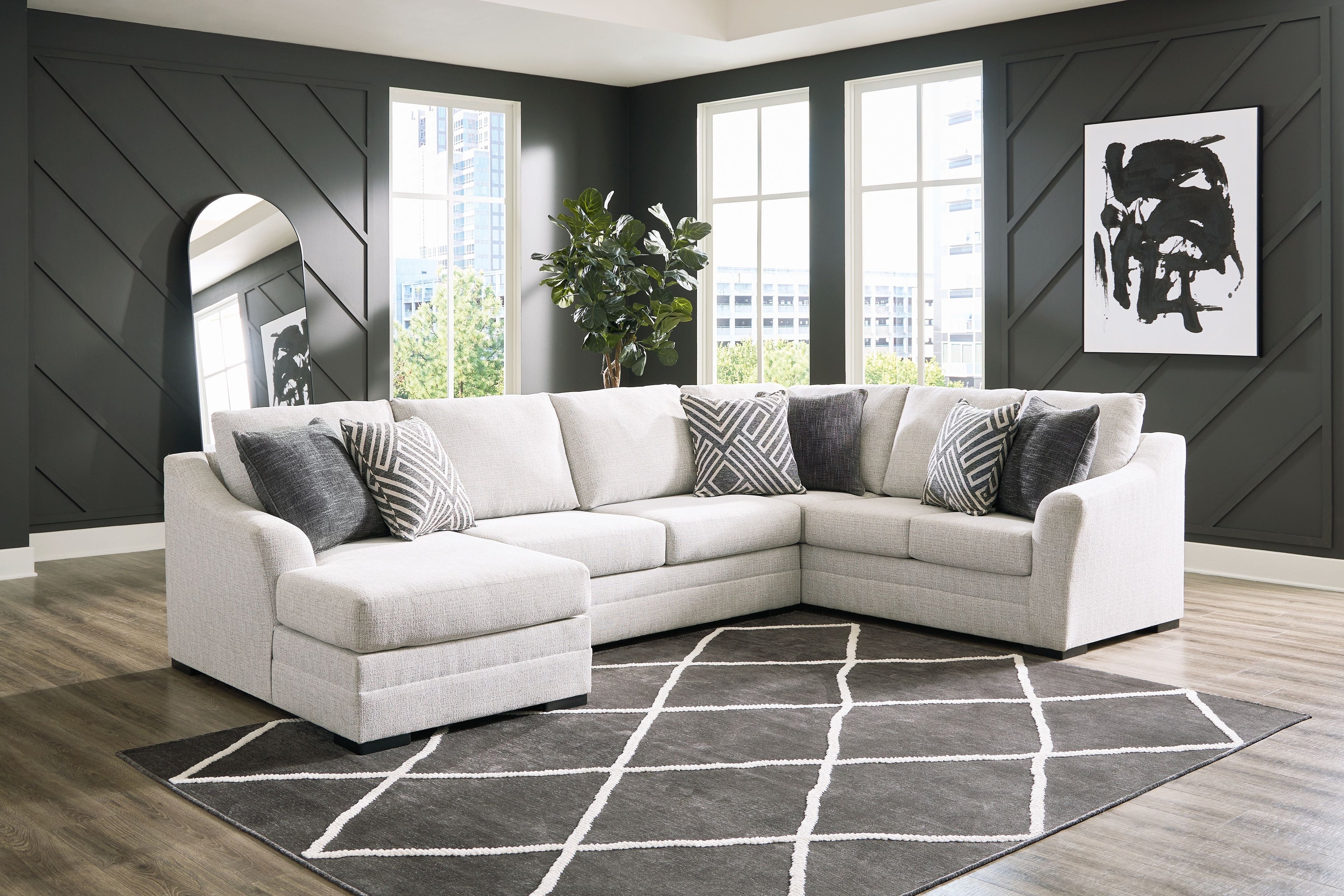 Stone sectional sofa with chaise, light upholstery and patterned accent pillows, square seat cushions