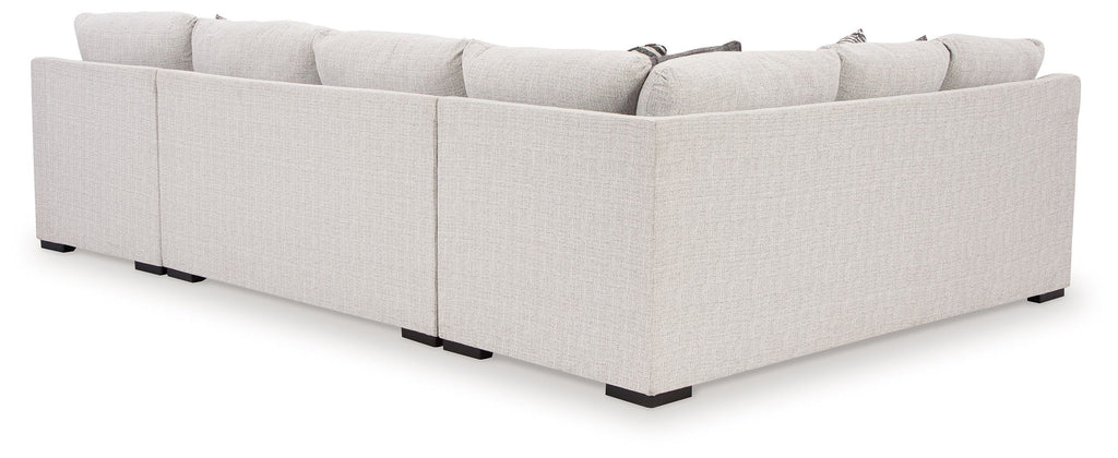 Stone sectional sofa back view with chaise, light upholstery and black feet