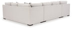 Stone sectional sofa side view, light upholstery with armrests and black feet