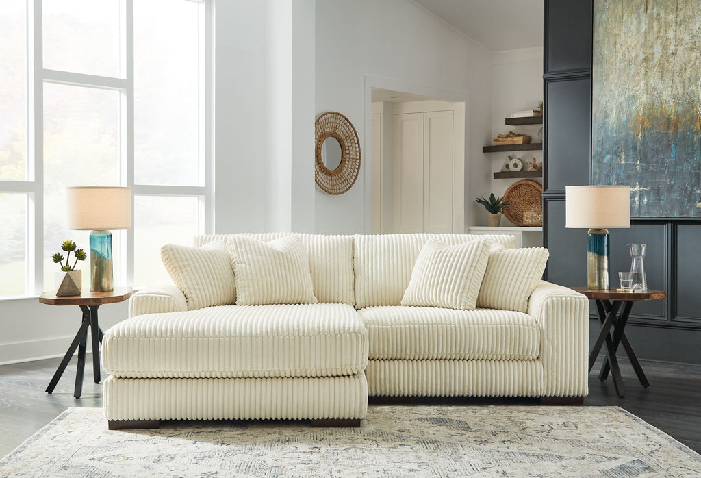 Ivory corduroy L-shaped sectional sofa with seat and back throw cushions