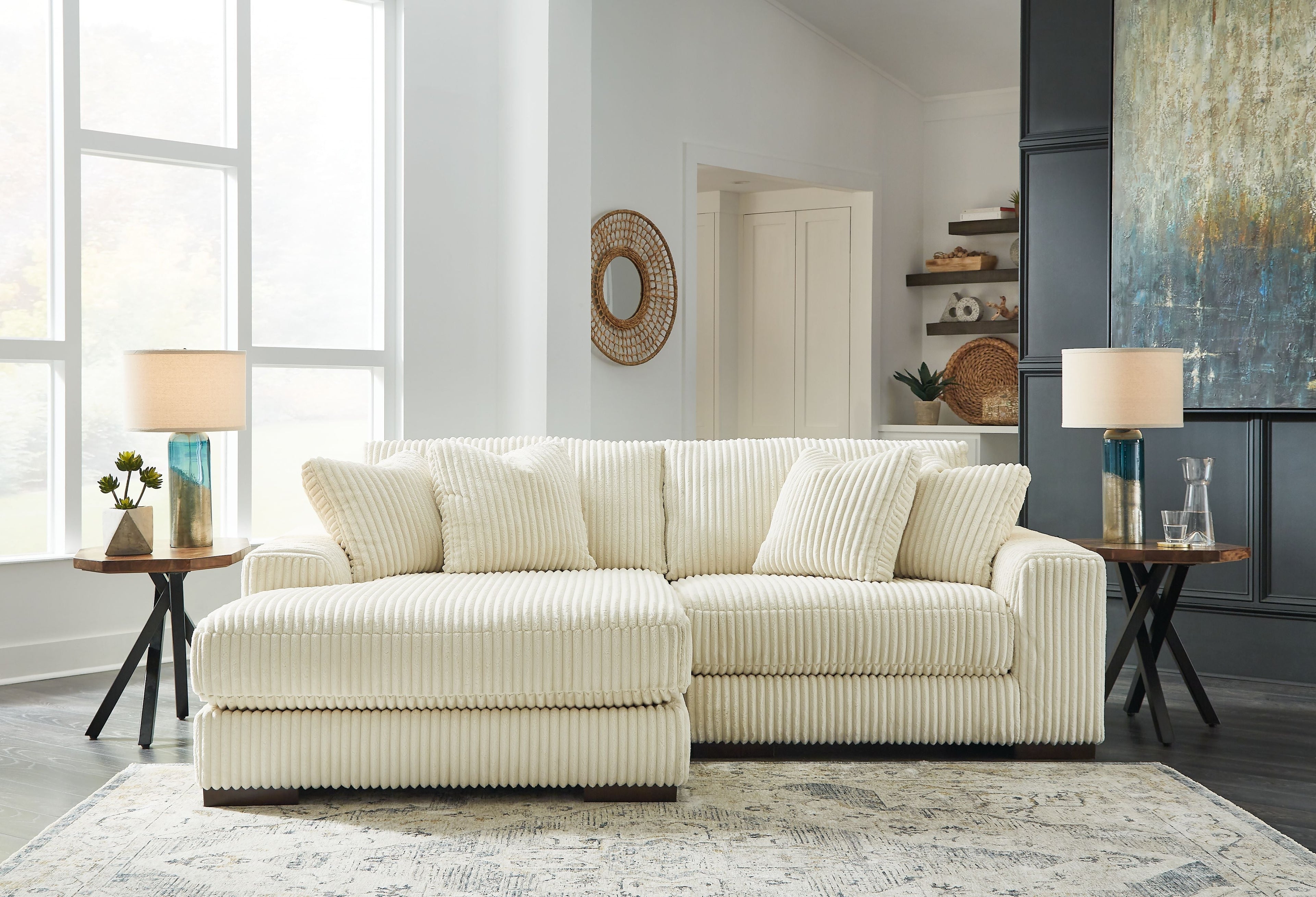 Ivory corduroy L-shaped sectional sofa with seat and back throw cushions