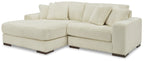 Ivory corduroy sectional sofa with chaise, tufted seat cushions, and back pillows