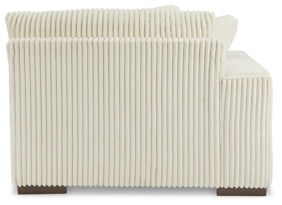 Ivory corduroy sectional sofa arm and side panel with vertical ribbed upholstery