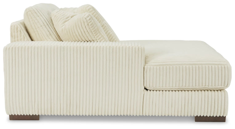 Ivory corduroy sectional sofa with rounded arm, side bolster, and back cushions