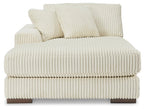 Ivory corduroy sectional sofa chaise with deep seat, segmented cushions, and pillows