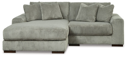 Light gray corduroy L-shaped sectional sofa with seat and back cushions