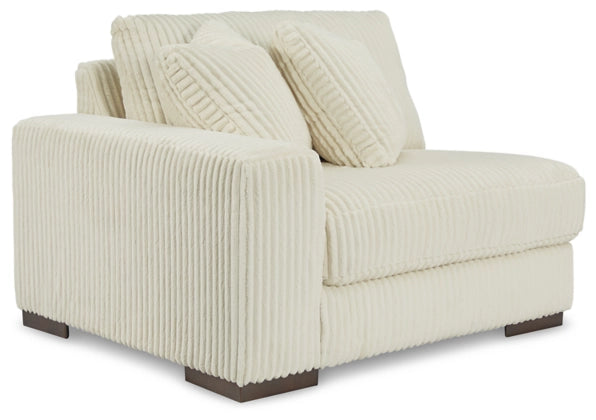 Ivory striped sectional sofa with rolled back cushions and two vertical throw pillows