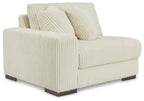 Ivory striped sectional sofa with rolled back cushions and two vertical throw pillows