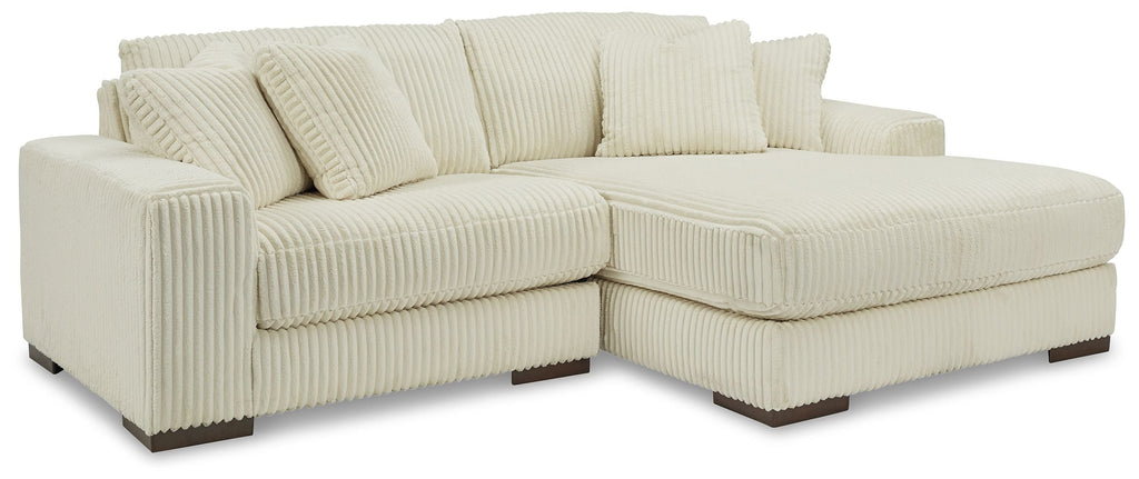 Ivory striped sectional sofa with track arms and tufted seat cushions