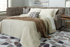 Gray sectional sofa bed with corner chaise, tufted headboard, white linens and decorative pillows