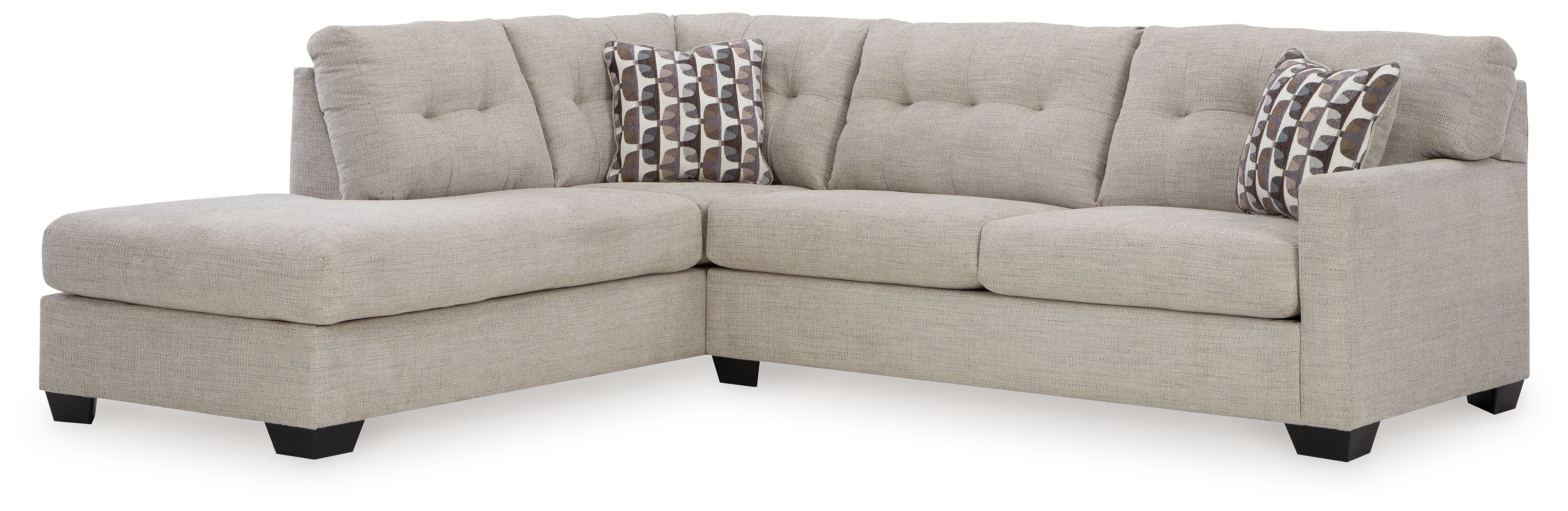 Light gray sectional sofa with corner chaise and patterned throw pillows