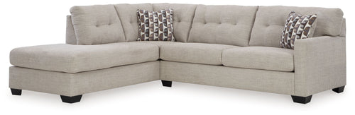 Light gray sectional sofa with corner chaise and patterned throw pillows