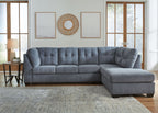 Gray sectional sofa with right-corner chaise, tufted back, and squared chaise arm